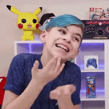 a boy with blue hair is standing in front of a shelf with a box that says legend games on it