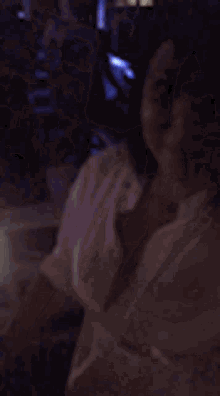 a blurry picture of a person dancing in a club with blue lights .
