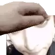 a close up of a person 's face with a hand covering it .