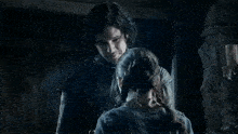a man and a woman are hugging each other in a dark room