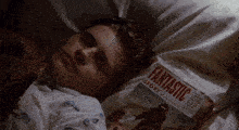 a man laying on a bed with a fantastic story magazine