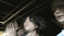 a blurry picture of a man and a woman standing next to each other