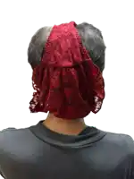 a man wearing a red lace headband covering his face