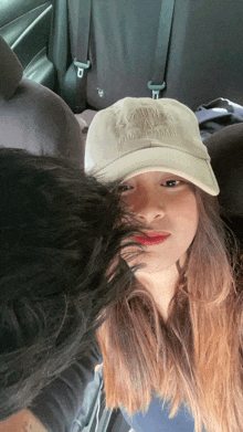 a woman wearing a hat that says ' hawaii ' on it looks at the camera