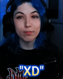 a person with blue hair is wearing headphones and says " xd " in the corner