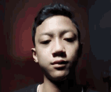 a young man is sticking his tongue out while making a funny face .