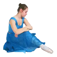 a woman in a blue dress and pointe shoes sits on the floor