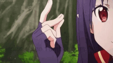 a girl with purple hair and red eyes is making a heart shape with her hands .
