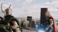 loki and thor are fighting each other with swords in a city .