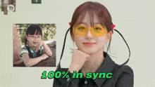 a girl wearing yellow sunglasses with the words 100 % in sync on the bottom