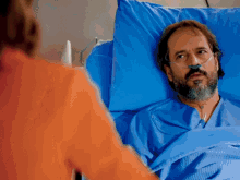 a man in a hospital bed with an oxygen mask