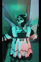 a skeleton dressed as a maid with wings and horns