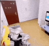 a cat is laying on a couch in a living room next to a tv .