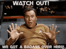a man in a star trek uniform is making a funny face and says watch out we got a badass over here .