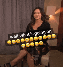 a woman is sitting in a chair with smiley faces around her and a sticker that says wait what is going on