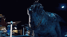 a dinosaur is standing in front of a building with its mouth open .