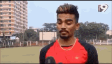a man in a red and black jersey with the number 9 on it