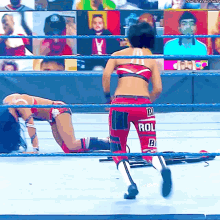a woman in a wrestling ring is wearing red shorts that say roll b