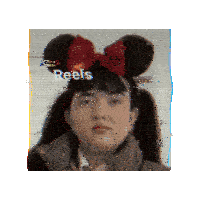a girl wearing a mickey mouse headband with the word reels above her