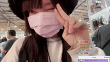 a girl wearing a face mask and a hat with the number 393 on the bottom