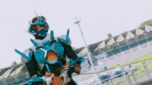 a man in a robot costume stands in front of empty bleachers