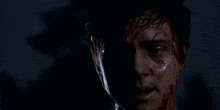 a close up of a man 's face covered in blood