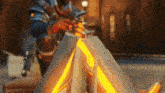 a man in armor is standing next to a fire .