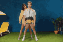 a man and a woman standing next to each other on a grassy field