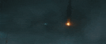 a large monster is standing in the dark with a light coming out of it 's mouth .