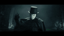 a man wearing a top hat and a mask with a smiley face