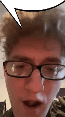 a close up of a person wearing glasses with a speech bubble above their head