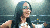 a woman with long black hair is wearing a white top