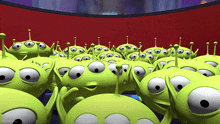 a bunch of green aliens from toy story are looking at something