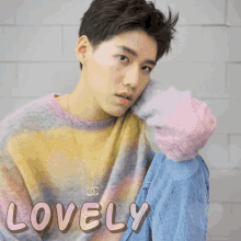 a young man wearing a sweater with hearts and the word lovely on it