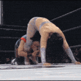 a woman is doing a handstand in a ring