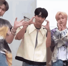 a group of young men are standing next to each other making funny faces .