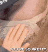 a close up of a woman 's face with the words " you 're so pretty " written on it