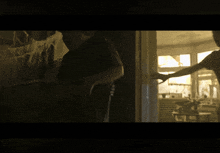 a man in a black shirt is standing in a room