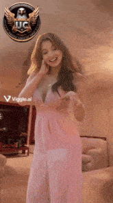 a woman in a pink dress is standing in a room with a jc logo