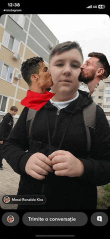 a phone screen shows a boy being kissed by a soccer player named messi-ronaldo