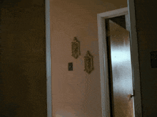 a door is open to a hallway with a clock on the wall