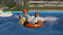 a man is floating in a swimming pool with a unicorn float