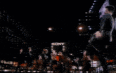 a blurry picture of a man dancing in front of a sign that says ' toshiba '
