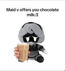 a stuffed animal holding a cup of chocolate milk