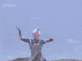 a man is standing in a field with the word ultraman on the bottom left
