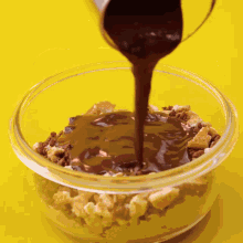a bowl of food with chocolate sauce being poured on top