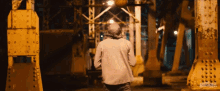 a man in a hooded jacket is walking across a bridge with the words marshall hill on the bottom