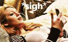 a woman laying on a bed with the word sigh written on the bottom