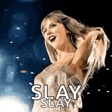 a woman in a dress is standing on a stage with her arms outstretched and her hair in the air .