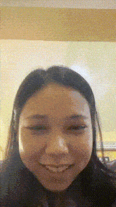 a close up of a woman 's face with a pixelated background